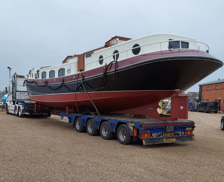 Large Dutch barge secured on a transport trailer